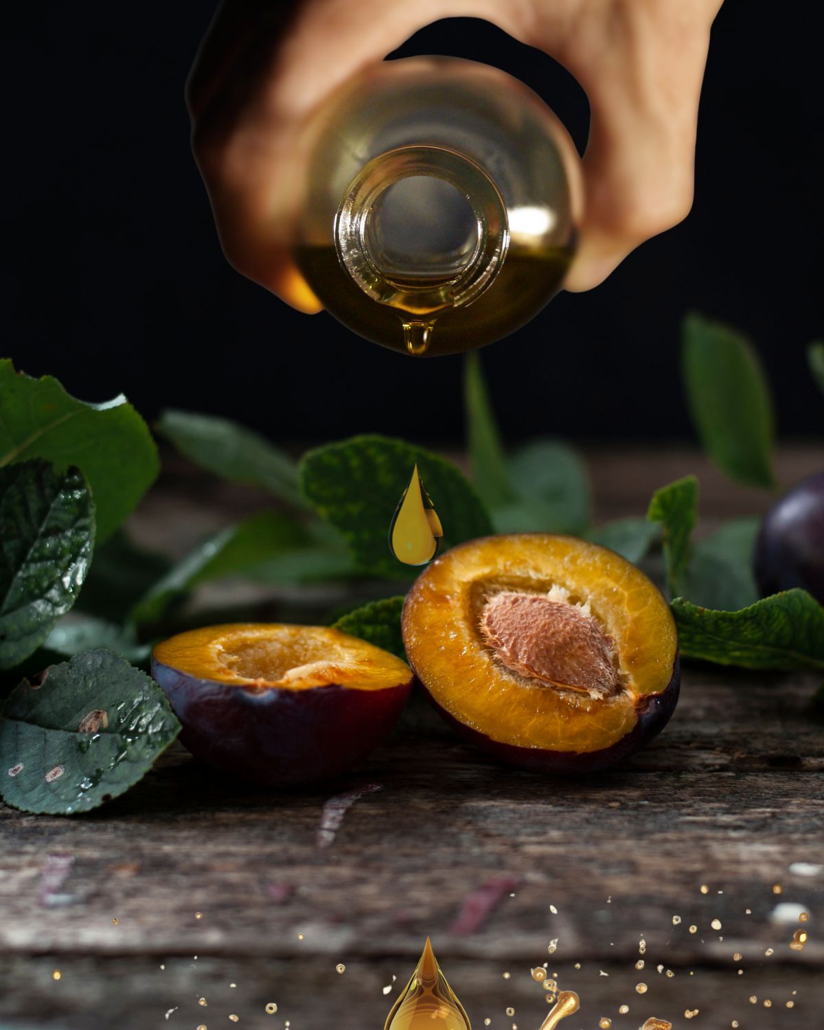 Plum kernel oil poured from a glass bottle
